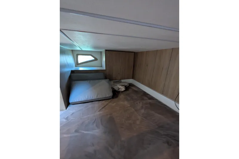 Mbvip Yacht Photos Pics 2023 NX Boats 340 Sport Coupe cabin interior with wooden paneling and compact sleeping area.