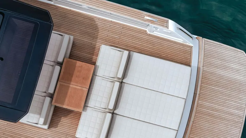 Yaaas Yacht Photos Pics 2024 Pardo Yachts P43 deck with white seating and wooden table, aerial view.