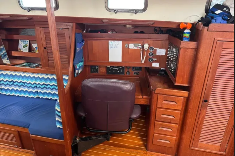 Bittersweet Yacht Photos Pics 1989 Tartan 4100 yacht interior with wooden cabinetry and blue patterned seating.