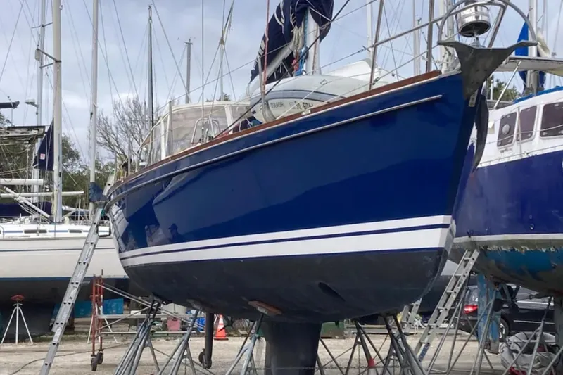 Bittersweet Yacht Photos Pics Blue 1989 Tartan 4100 sailboat on stands in a marina.