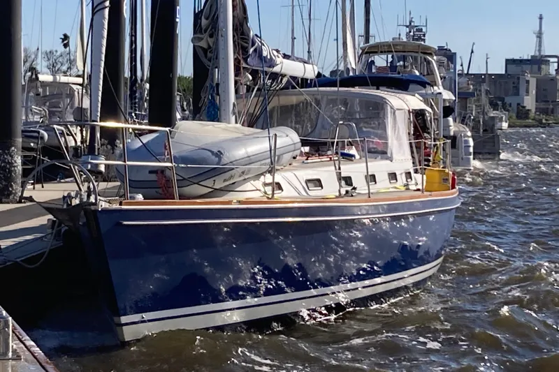 Bittersweet Yacht Photos Pics Sailboat docked in marina, 1998 Tartan 4100 model, blue hull, sunny day.