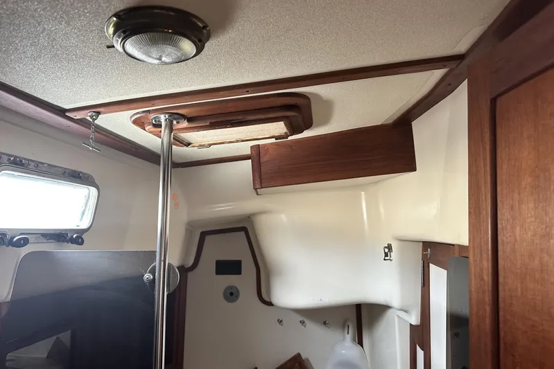 Bittersweet Yacht Photos Pics Interior of a 1998 Tartan 4100 sailboat featuring wood accents and a ceiling light.