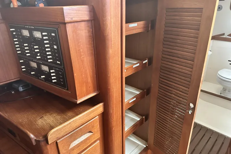 Bittersweet Yacht Photos Pics 1998 Tartan 4100 yacht interior with wooden cabinetry and electrical panel.