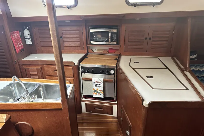 Bittersweet Yacht Photos Pics Cozy 1998 Tartan 4100 yacht kitchen with wooden cabinets and modern appliances.