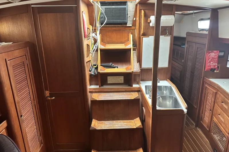 Bittersweet Yacht Photos Pics Interior of a 1998 Tartan 4100 sailboat with wooden cabinetry and stairs.