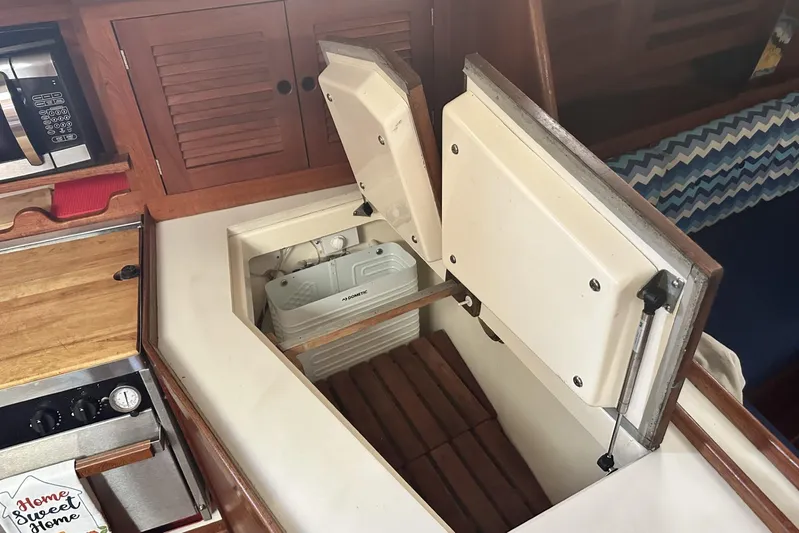 Bittersweet Yacht Photos Pics 1998 Tartan 4100 yacht interior with open storage compartment and microwave.