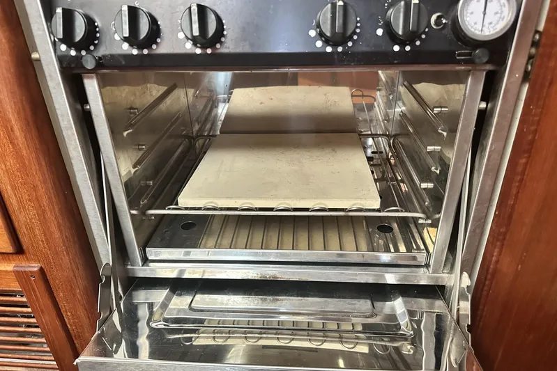 Bittersweet Yacht Photos Pics 1998 Tartan 4100 oven with stone baking tray, stainless steel interior, and control knobs.