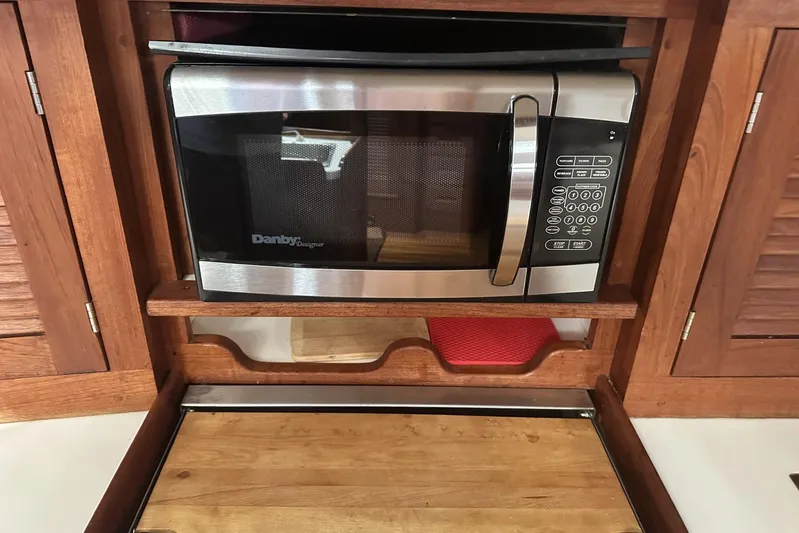 Bittersweet Yacht Photos Pics Microwave in wooden cabinet on Tartan 4100, 1998 model yacht interior.