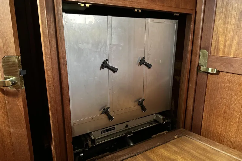 Bittersweet Yacht Photos Pics Engine compartment of a 1998 Tartan 4100 sailboat with wooden paneling.