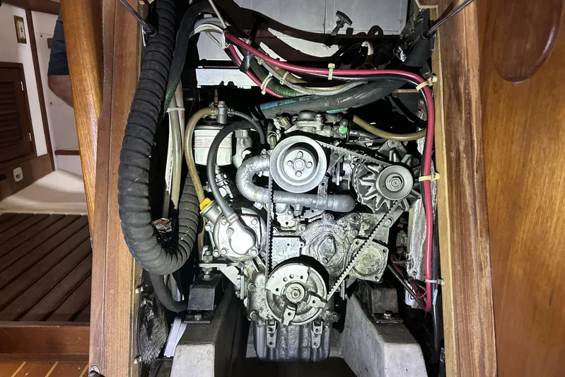 Bittersweet Yacht Photos Pics Engine compartment of a 1998 Tartan 4100 sailboat, showcasing mechanical components and wiring.