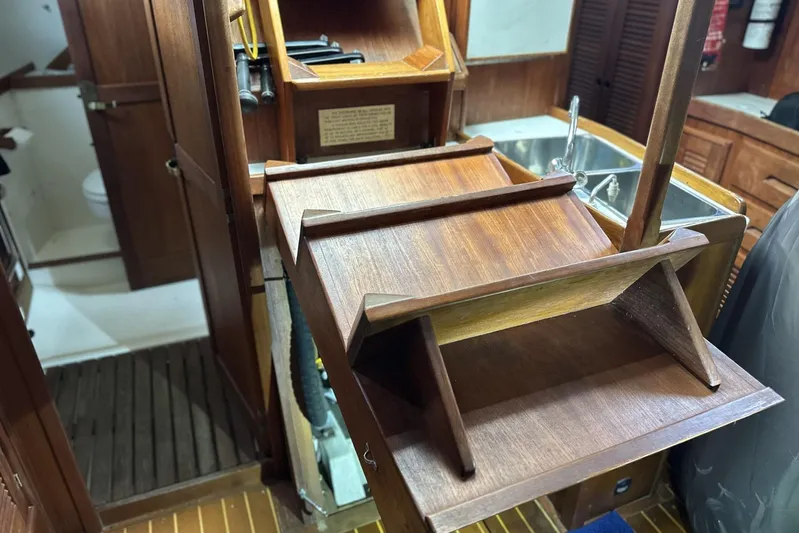 Bittersweet Yacht Photos Pics Interior of a 1998 Tartan 4100 sailboat, featuring wooden steps and a compact kitchen area.
