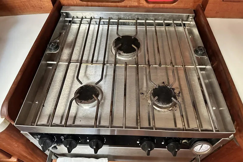 Bittersweet Yacht Photos Pics Three-burner stainless steel stove on a 1998 Tartan 4100 yacht.