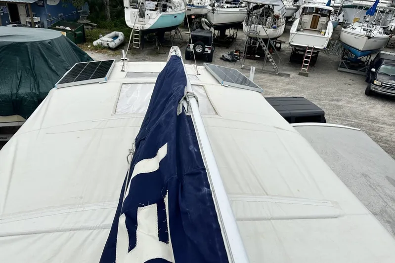 Bittersweet Yacht Photos Pics Rooftop view of a 1998 Tartan 4100 sailboat with solar panels in a boatyard.