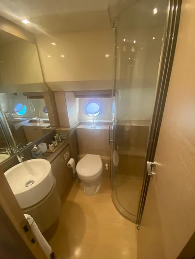  Yacht Photos Pics Luxurious bathroom on 2012 Ferretti Yachts 720, featuring modern fixtures and a porthole window.