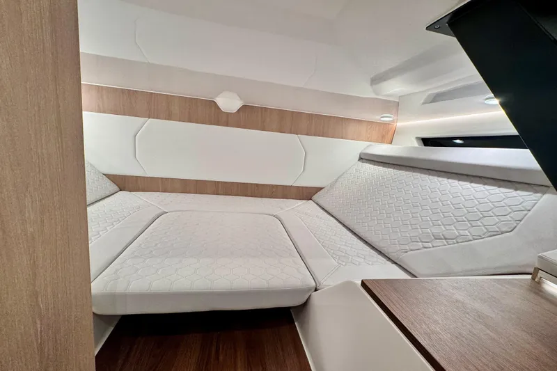 Maxim Yachts | Max43 Race Yacht Photos Pics Luxurious interior cabin of 2026 Maxim Yachts 43 Race, featuring elegant white and wood finishes.