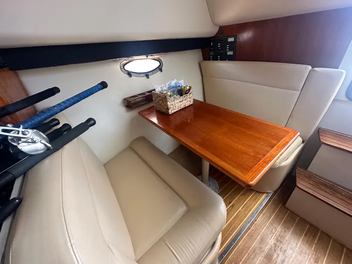 Marisol Yacht Photos Pics 2006 Tiara Yachts 2900 interior with wooden table and beige seating.
