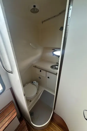 Marisol Yacht Photos Pics Compact bathroom in a 2006 Tiara Yachts 2900, featuring a toilet, sink, and shower.