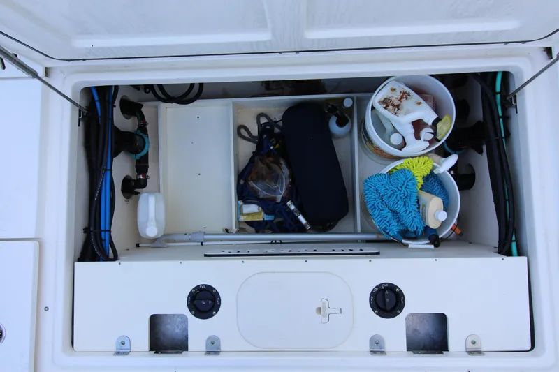 Better Than Most Yacht Photos Pics Storage compartment of a 2015 Boston Whaler 320 Outrage, organized with cleaning supplies.