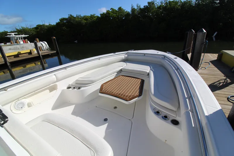 Better Than Most Yacht Photos Pics 2015 Boston Whaler 320 Outrage boat interior with seating and wooden table.
