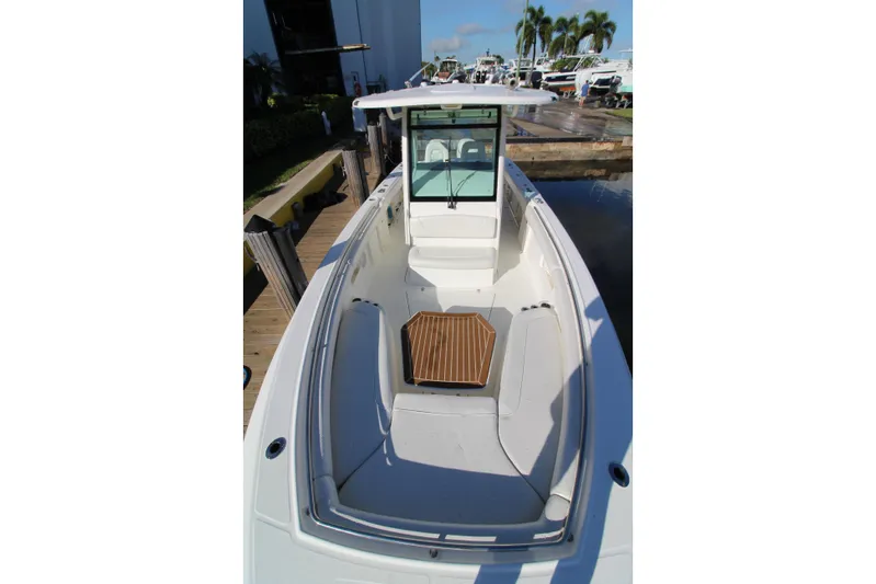 Better Than Most Yacht Photos Pics 2015 Boston Whaler 320 Outrage boat docked, showcasing spacious seating and sleek design.