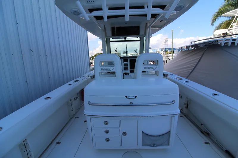 Better Than Most Yacht Photos Pics 2015 Boston Whaler 320 Outrage boat interior with seating and storage compartments.