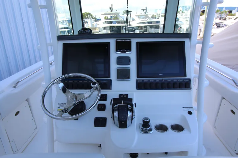Better Than Most Yacht Photos Pics 2015 Boston Whaler 320 Outrage helm with dual screens and steering wheel.
