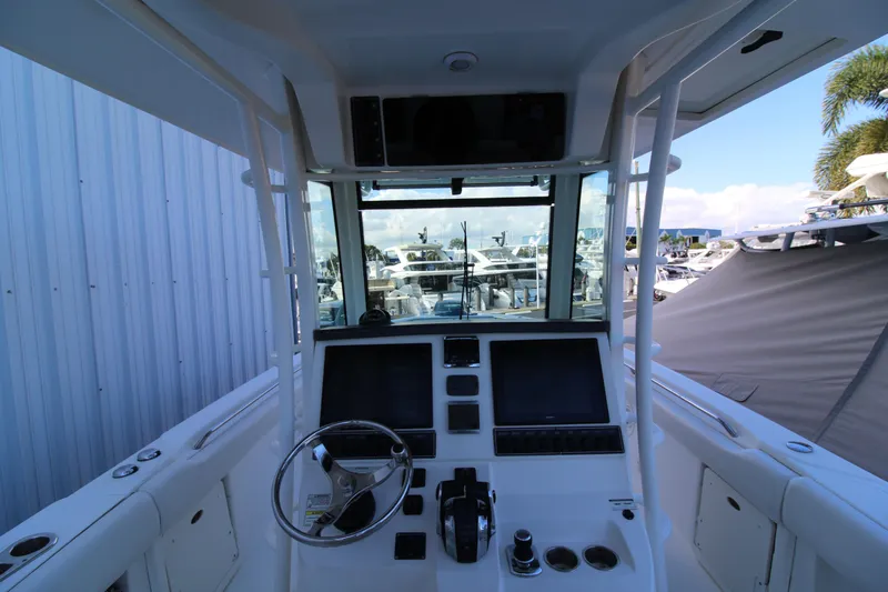 Better Than Most Yacht Photos Pics 2015 Boston Whaler 320 Outrage helm with dual screens and steering wheel.