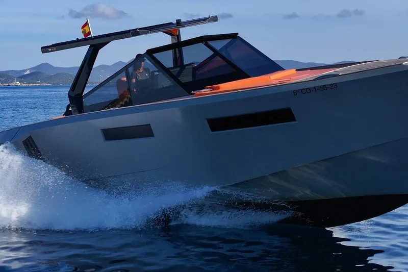 Mistral Yacht Photos Pics 2023 Evo Yachts R4 XT cruising on open water with mountains in the background.