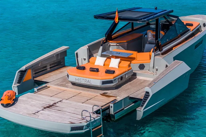 Mistral Yacht Photos Pics 2023 Evo Yachts R4 XT luxury yacht with spacious deck and modern design on clear blue water.