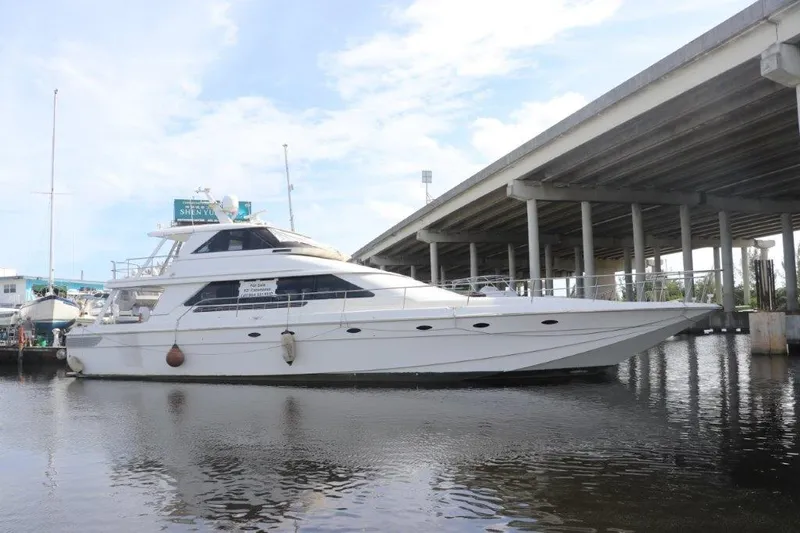  Yacht Photos Pics 1996 Mares Motor Yacht docked near a bridge on a sunny day.