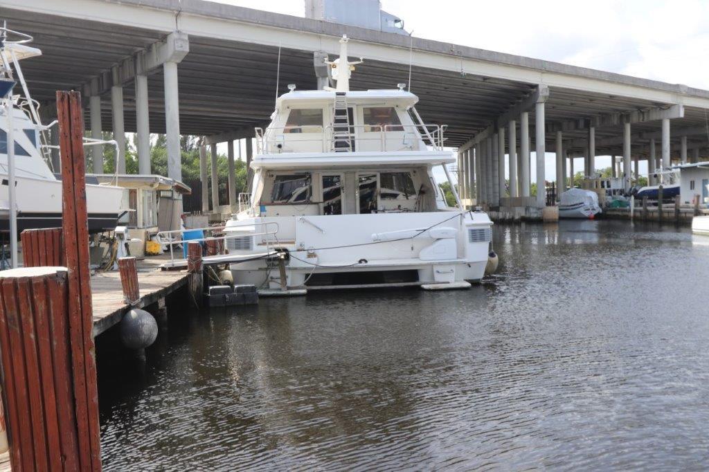 1996 Mares Motor Yacht docked at marina under bridge.