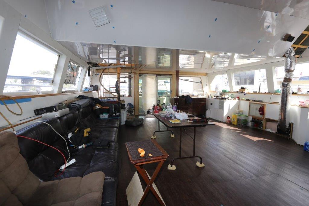 Interior of a 1996 Mares Motor Yacht under renovation, featuring a spacious cabin.