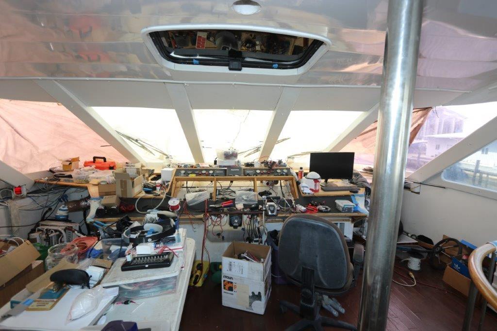 Interior of a 1996 Mares Motor Yacht with cluttered workspace and equipment.