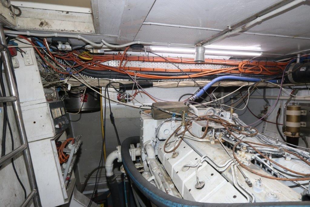 Engine room of a 1996 Mares Motor Yacht with visible wiring and machinery.