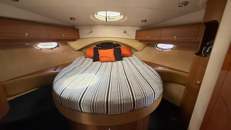  Yacht Photos Pics Luxurious cabin interior of 2003 Regal Commodore 4260 yacht with striped bedding.