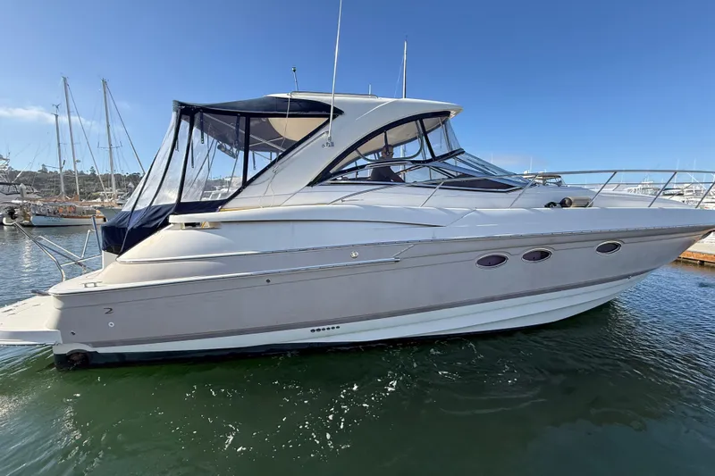  Yacht Photos Pics 2003 Regal Commodore 4260 yacht docked in a marina under clear blue skies.