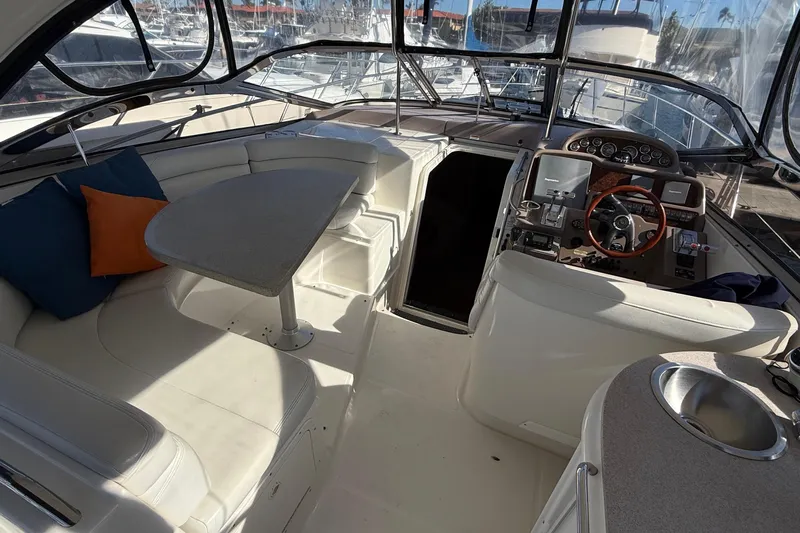  Yacht Photos Pics Luxurious 2003 Regal Commodore 4260 yacht interior with helm, seating, and table.