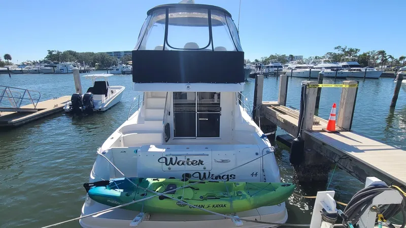 Yacht Photos Pics 2006 Sea Ray 44 Sedan Bridge docked with kayak, sunny marina background.