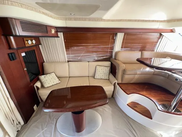  Yacht Photos Pics Luxurious interior of 2006 Sea Ray 44 Sedan Bridge yacht with elegant seating and wooden accents.