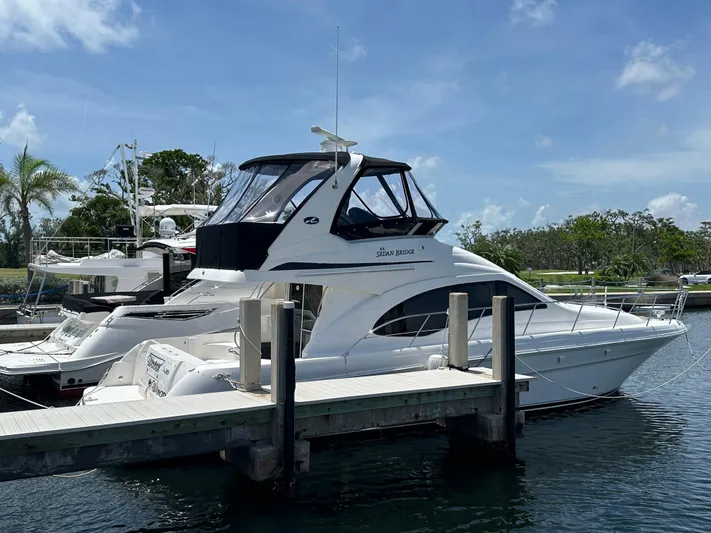  Yacht Photos Pics 2006 Sea Ray 44 Sedan Bridge yacht docked at marina under clear blue sky.