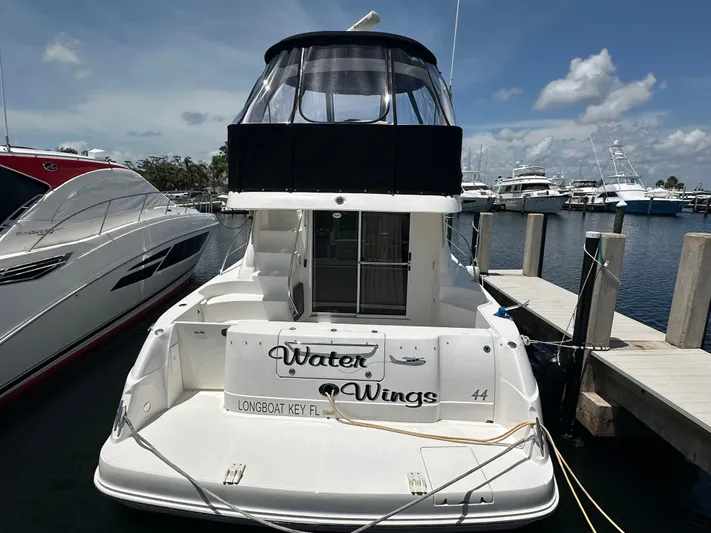  Yacht Photos Pics 2006 Sea Ray 44 Sedan Bridge yacht docked at marina under clear sky.