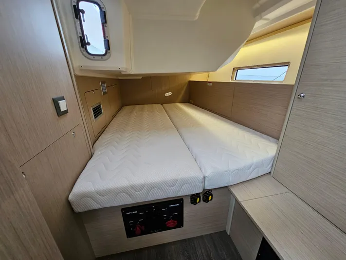  Yacht Photos Pics 2024 Beneteau Oceanis 40.1 cabin interior with bed and wooden finish.
