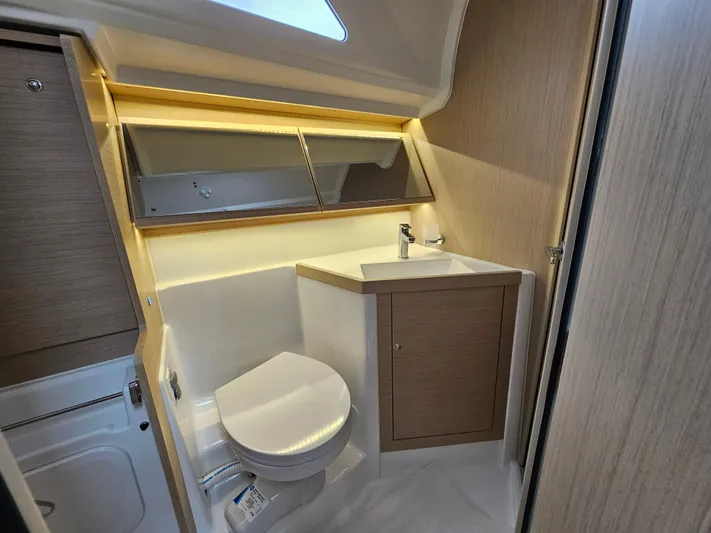  Yacht Photos Pics 2024 Beneteau Oceanis 40.1 yacht bathroom with modern fixtures and wood accents.