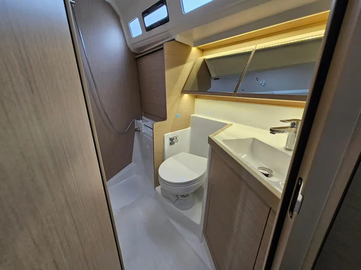  Yacht Photos Pics 2024 Beneteau Oceanis 40.1 yacht bathroom with modern fixtures and wood accents.