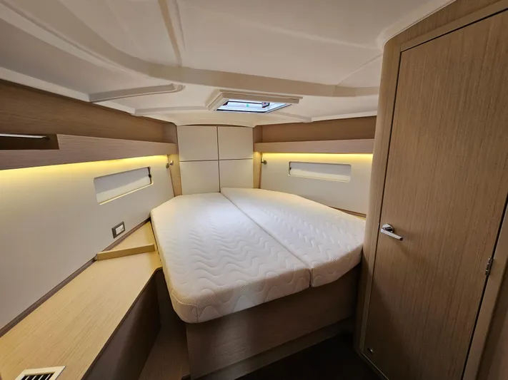  Yacht Photos Pics 2024 Beneteau Oceanis 40.1 cabin interior with modern design and cozy bed.