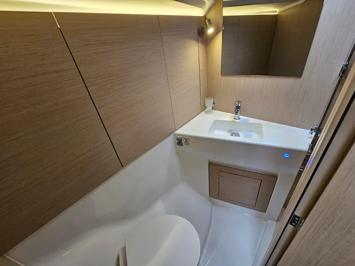 Yacht Photos Pics 2024 Beneteau Oceanis 40.1 bathroom with modern fixtures and wood paneling.