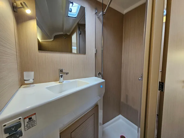  Yacht Photos Pics 2024 Beneteau Oceanis 40.1 yacht bathroom with modern sink and shower.