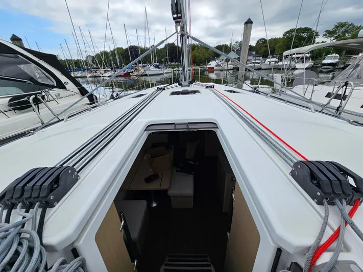  Yacht Photos Pics 2024 Beneteau Oceanis 40.1 sailboat deck view at marina, showcasing rigging and cabin entrance.