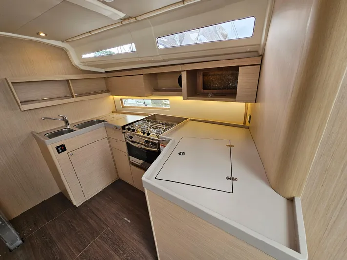  Yacht Photos Pics 2024 Beneteau Oceanis 40.1 yacht kitchen interior with modern appliances and wood finish.