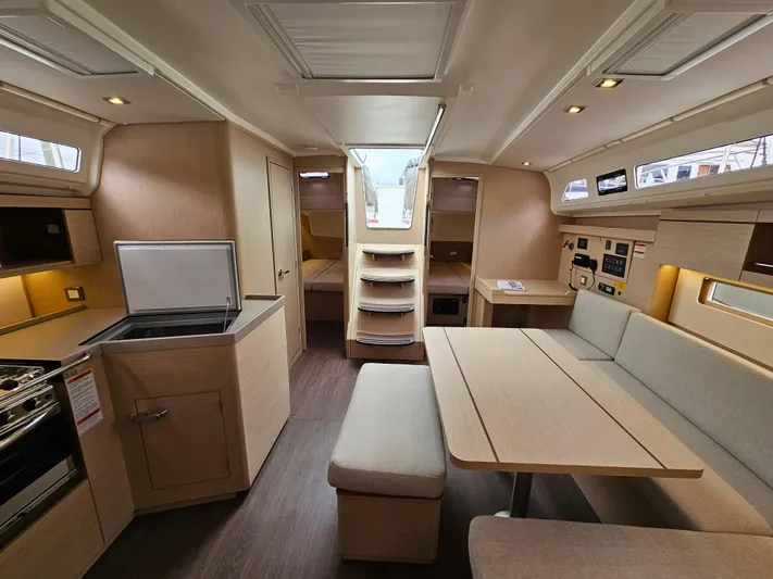  Yacht Photos Pics 2024 Beneteau Oceanis 40.1 interior with modern kitchen, dining area, and cozy seating.